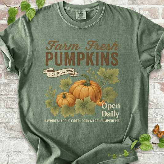 Vintage Pumpkin T-shirt on Comfort Colors™ Moss – includes two illustrated pumpkins and curling leaves with fall fair vibes and cozy farmhouse text like "Corn Maze" and "Pumpkin Pie"