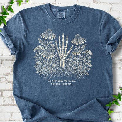 Denim Comfort Colors® T-shirt featuring a cream botanical skeleton-hand graphic reading In the end, we'll all become compost