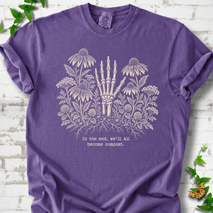 Grape Comfort Colors® T-shirt featuring a cream botanical skeleton-hand graphic reading In the end, we'll all become compost