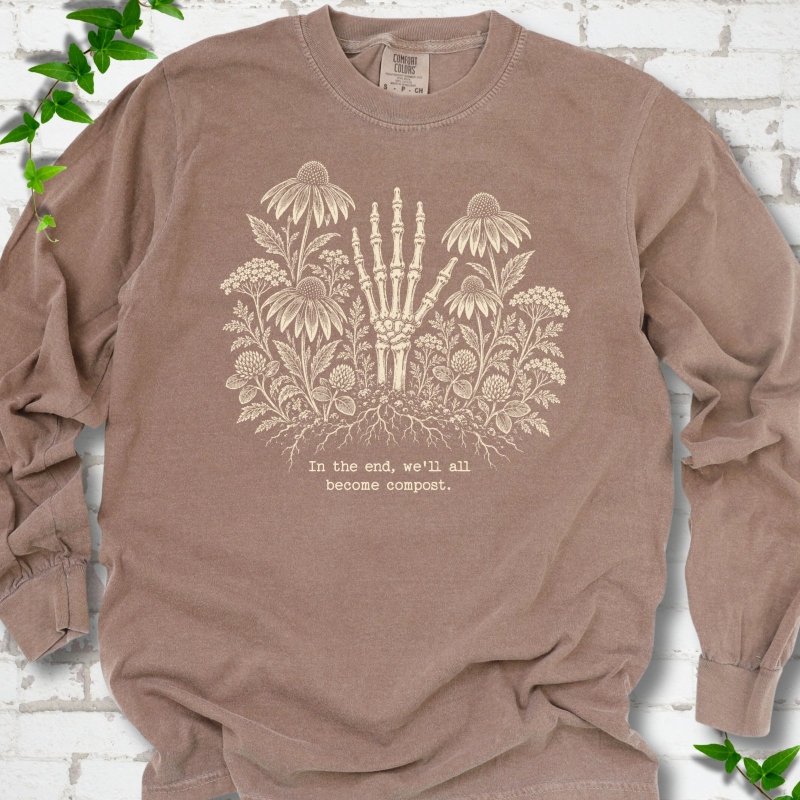 Espresso Comfort Colors® long sleeve T-shirt featuring a cream botanical skeleton-hand graphic reading In the end, we'll all become compost