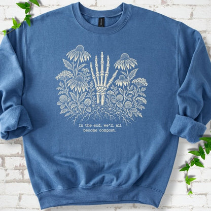 Indigo Blue classic sweatshirt featuring a cream botanical skeleton-hand graphic reading In the end, we'll all become compost