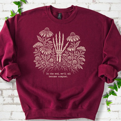 Maroon classic sweatshirt featuring a cream botanical skeleton-hand graphic reading In the end, we'll all become compost
