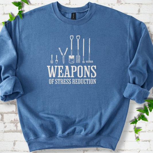 Indigo Blue Gildan® 18000 crewneck sweatshirt flat lay featuring garden tools and the words “Weapons of Stress Reduction.”