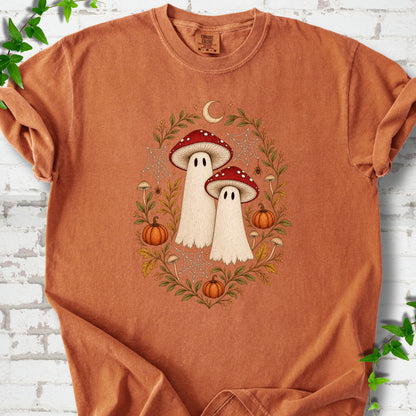 Yam Comfort Colors® T-shirt laid flat, showing two cream ghosts wearing red mushroom caps, surrounded by small pumpkins, autumn leaves and a crescent moon.