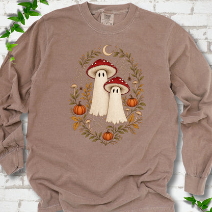 Espresso Comfort Colors® long sleeve T-shirt laid flat, showing two cream ghosts wearing red mushroom caps, surrounded by small pumpkins, autumn leaves and a crescent moon.