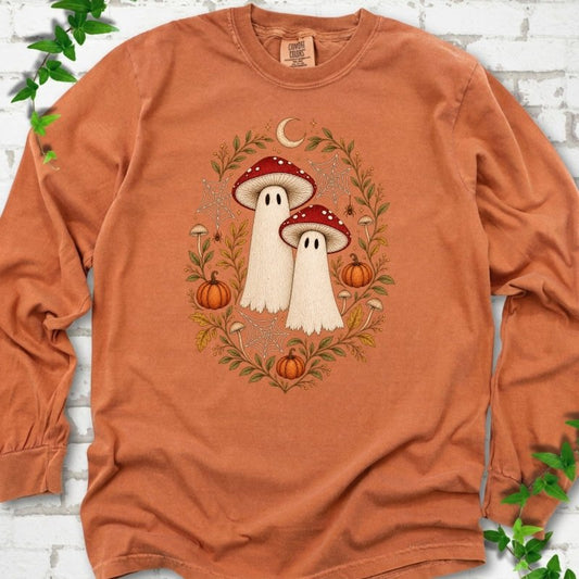 Yam Comfort Colors® long sleeve T-shirt laid flat, showing two cream ghosts wearing red mushroom caps, surrounded by small pumpkins, autumn leaves and a crescent moon.