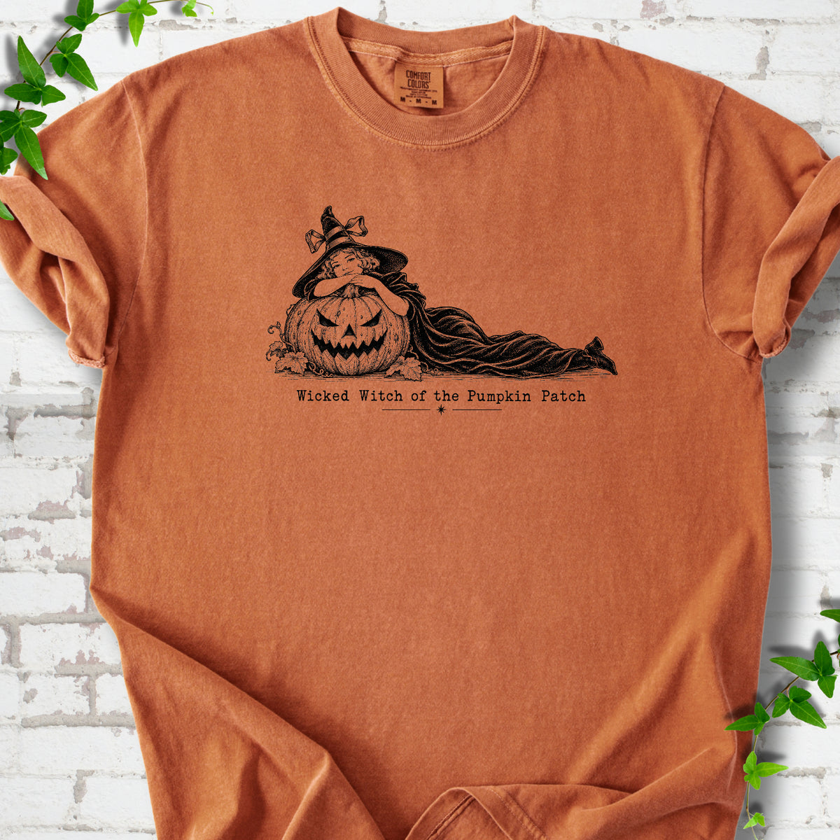 Wicked Witch of the Pumpkin Patch Halloween T-shirt in Yam with witch and jack-o'-lantern graphic