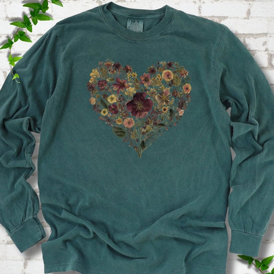 Blue Spruce Comfort Colors® long sleeve T-shirt flat lay featuring a heart formed from delicate wildflowers.