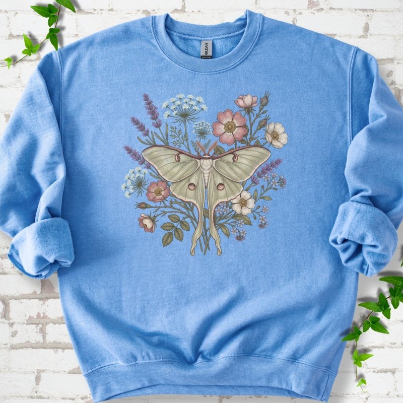 Carolina Blue Gildan® 18000 crewneck sweatshirt flat lay featuring a pale luna moth surrounded by pink, lavender, blue and white wildflowers.