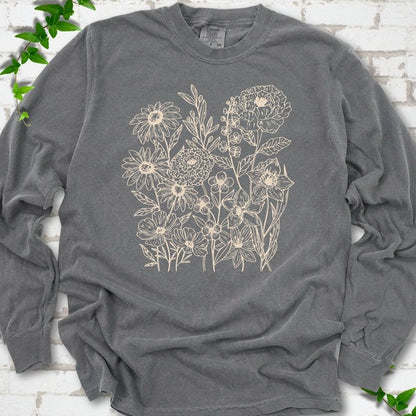 Pepper Comfort Colors® long sleeve T-shirt flat lay featuring delicate cream wildflower line art.