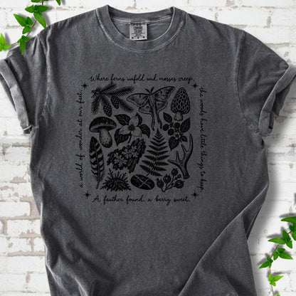 Pepper gray short-sleeve tee with woodland finds engraving in black ink, framed by "a world of wonder at our feet".