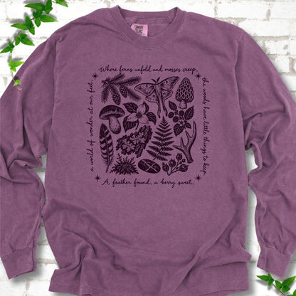 Berry purple long-sleeve tee with woodland finds engraving in dark plum ink, framed by "a world of wonder at our feet".