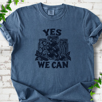 Denim Comfort Colors® T-shirt flat lay featuring preserved tomatoes in jars and the words “Yes We Can.”