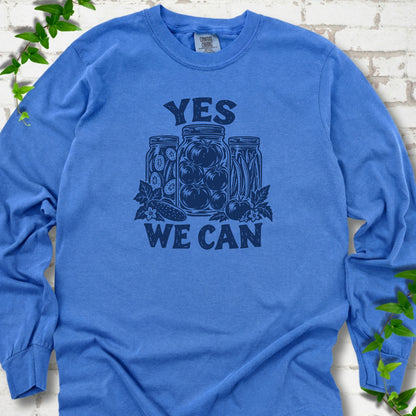 Flo Blue Comfort Colors® long sleeve T-shirt flat lay featuring preserved tomatoes in jars and the words “Yes We Can.”