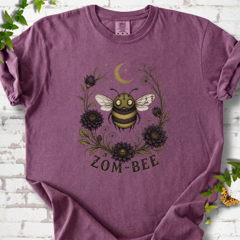 Berry Zom-Bee Gothic Garden Comfort Colors® T-shirt with a zombie bee, crescent moon and dark flowers
