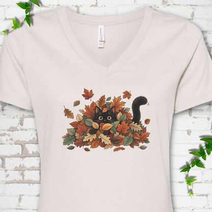 Heather Dust Bella Canvas® V-neck T-shirt flat lay featuring a black cat peeking from a pile of orange and green autumn leaves.