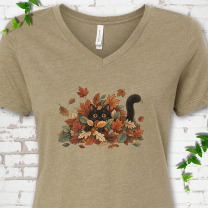 Heather Olive Bella Canvas® V-neck T-shirt flat lay featuring a black cat peeking from a pile of orange and green autumn leaves.