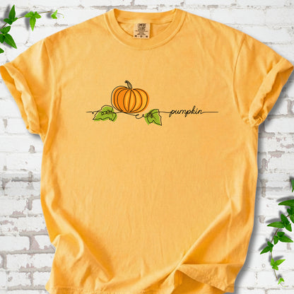 Citrus Comfort Colors® T-shirt flat lay featuring a minimalist orange pumpkin, green leaves and delicate black script.