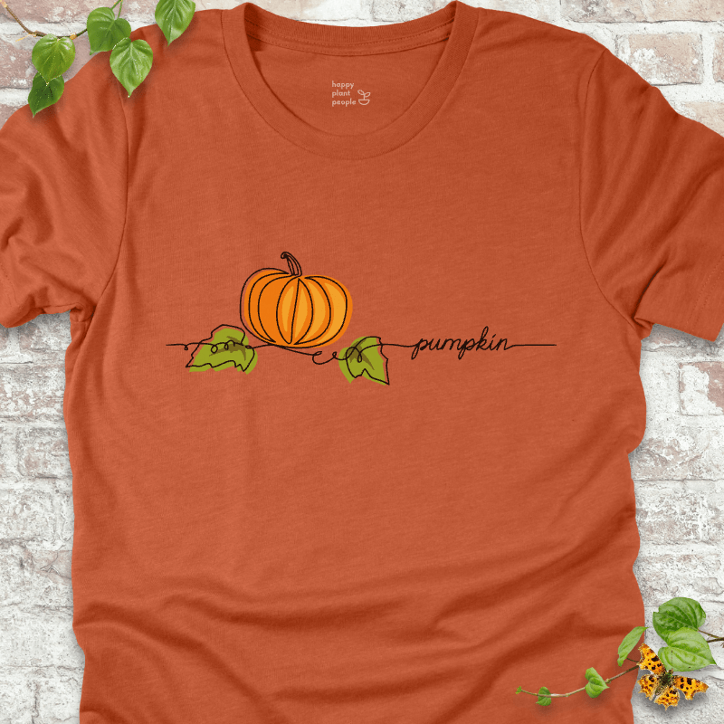 Minimalist pumpkin illustration on an orange T-shirt