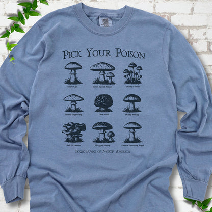 Blue Jean Comfort Colors® long sleeve T-shirt flat lay featuring a Pick Your Poison field guide of toxic North American mushrooms.