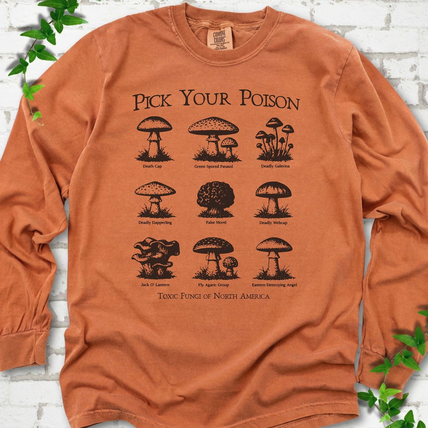 Yam Comfort Colors® long sleeve T-shirt flat lay featuring a Pick Your Poison field guide of toxic North American mushrooms.