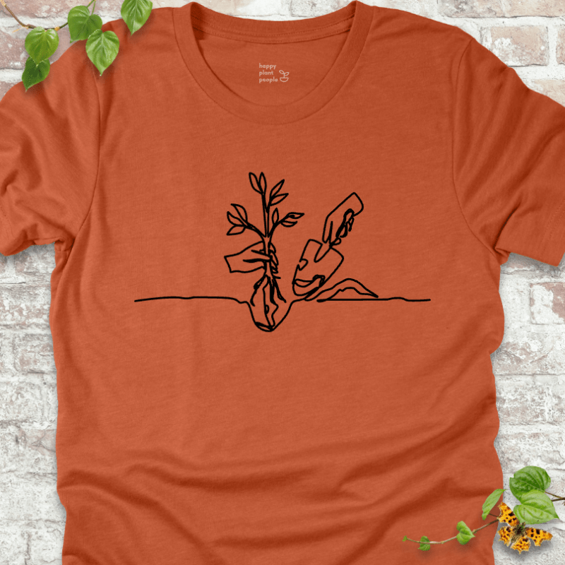 Minimalist planting illustration on an orange T-shirt