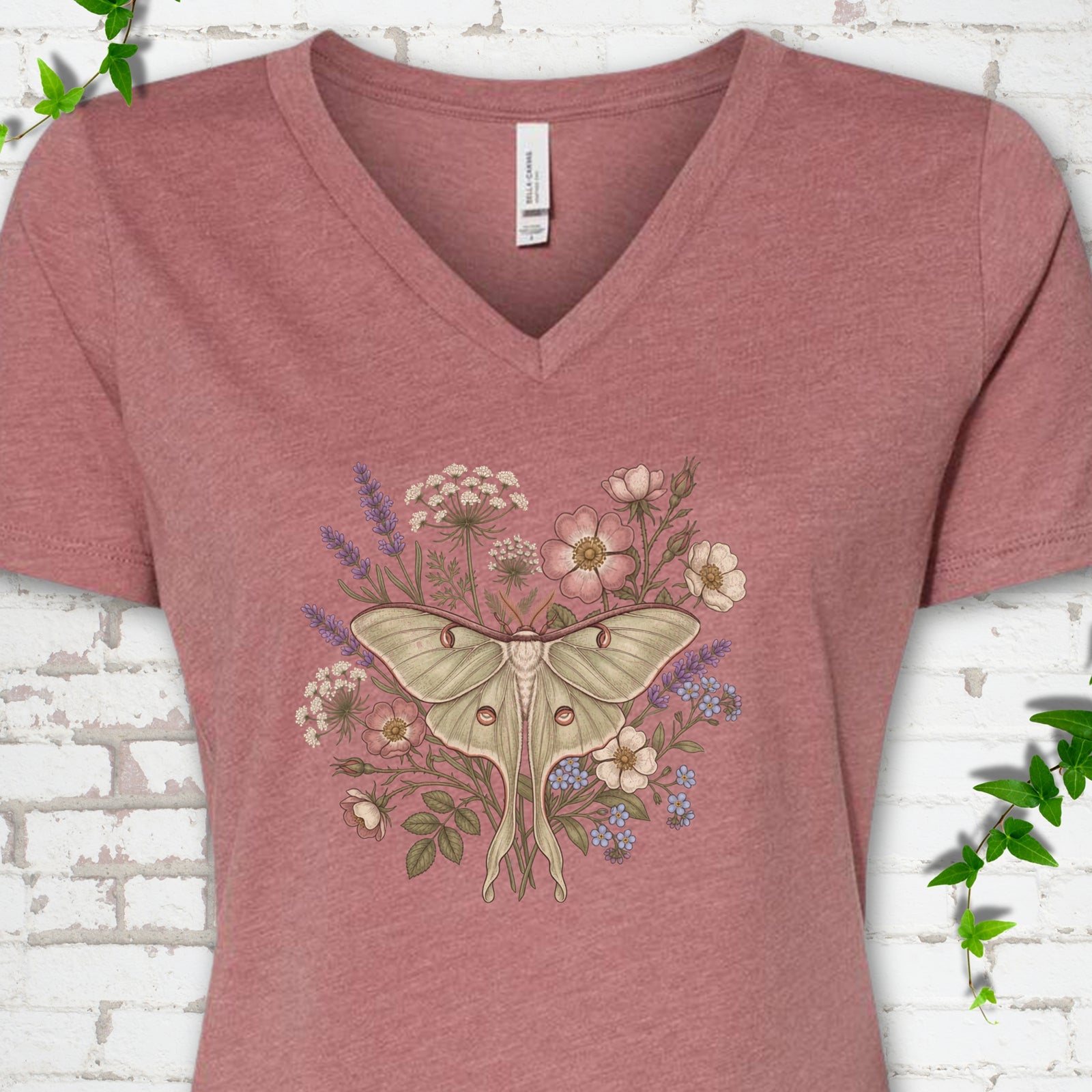 Heather Mauve Bella Canvas® V-neck T-shirt flat lay featuring a pale luna moth surrounded by pink, lavender, blue and white wildflowers.