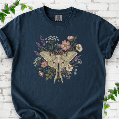 Midnight Comfort Colors® T-shirt flat lay featuring a pale luna moth surrounded by pink, lavender, blue and white wildflowers.